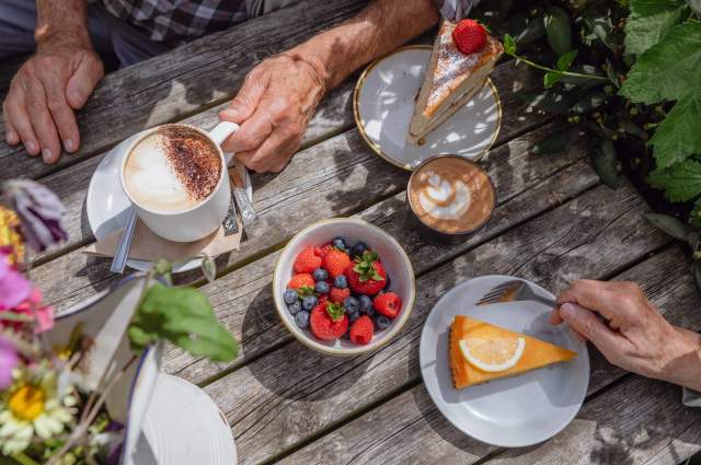 A table with cakes, fruit and coffee at Great Dixter, Sussex