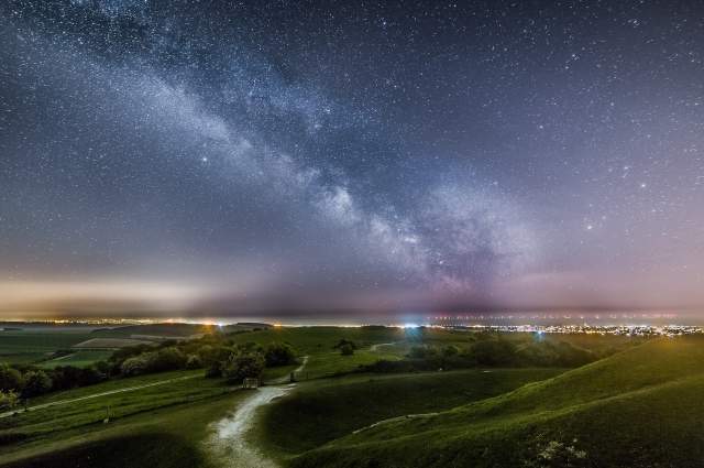 Beautiful night time landscape of the South Downs with star constellations in the night sky
