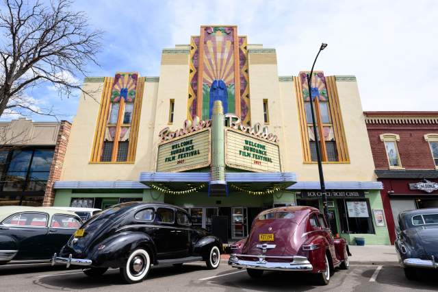 Boulder Theater marquee reads Welcome Sundance Film Festival with old cars parked in front