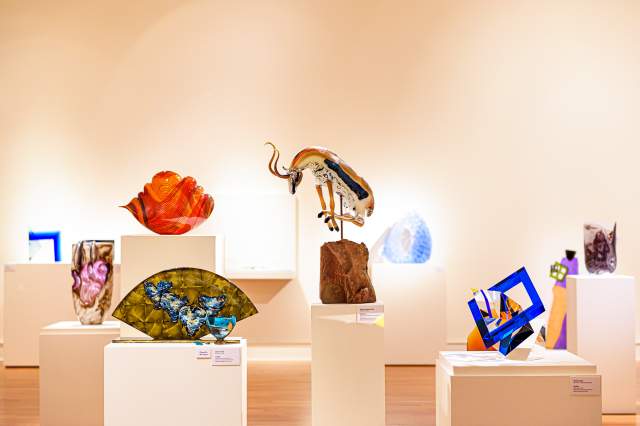 several glass sculptures in a gallery at fort wayne museum of art