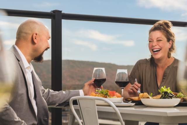 With Rib Mountain in the background, a couple dines at the rooftop restaurant, The Velveteen Plum