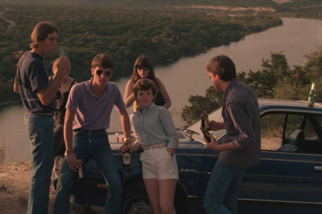 Blood Simple screengrab showing a group of young people leaning up against a car on top of Mount Bonnell