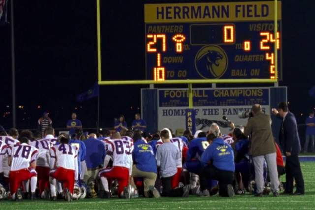 Friday Night Lights Screengrab showing a football team kneeling on Herrmann Field in front of a goal with scoreboard showing score of 27 to 24