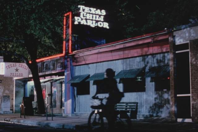 Grindhouse screengrab showing the exterior of a bar with a neon sign reading Texas Chili Parlor