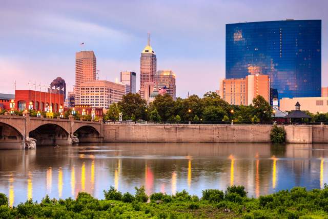 The White River reflects the Indianapolis skyline