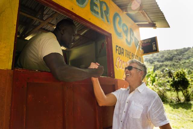 Image of a tourist giving a handshake to a local