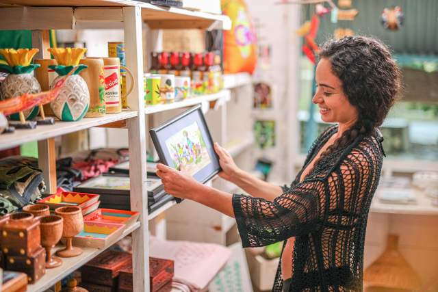 Woman shopping for art in Treasure Beach