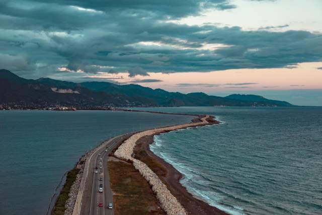 An aerial view of the Palisadoes Road leading to the Norman Manley International Airport in Kingston. The road is flanked by Kingston Harbour on the left and the Caribbean Sea on the right.