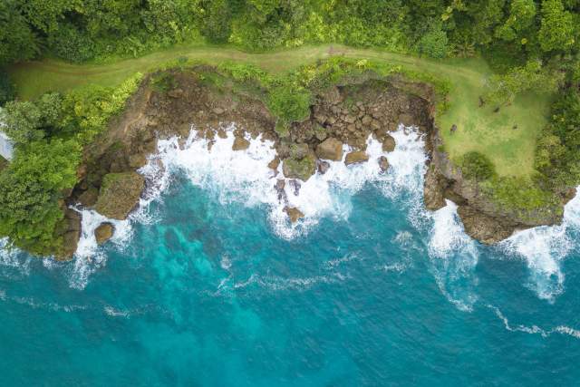 Aerial view of the sea crashing against the cliffs at Frenchman's Cove in Port Antonio, Jamaica