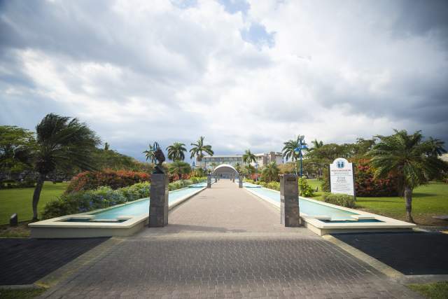 A walkway flanked by reflecting pools at Emancipation Park in Kingston, Jamaica