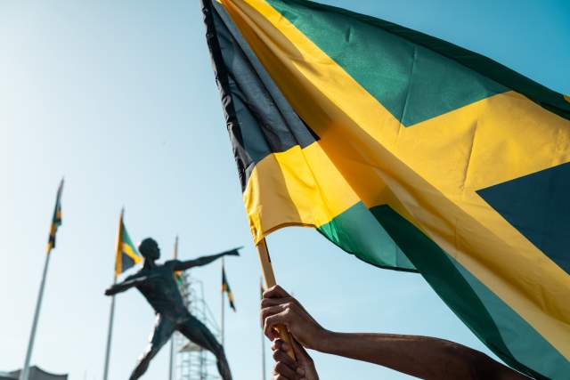 Jamaica Flag Celebration at National Stadium Bolt Statue