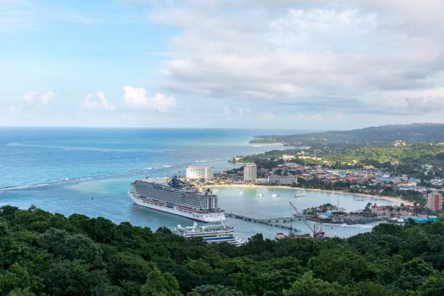 View of the Ocho Rios coastline as seen from the hills. A large cruise ship is at the pier.