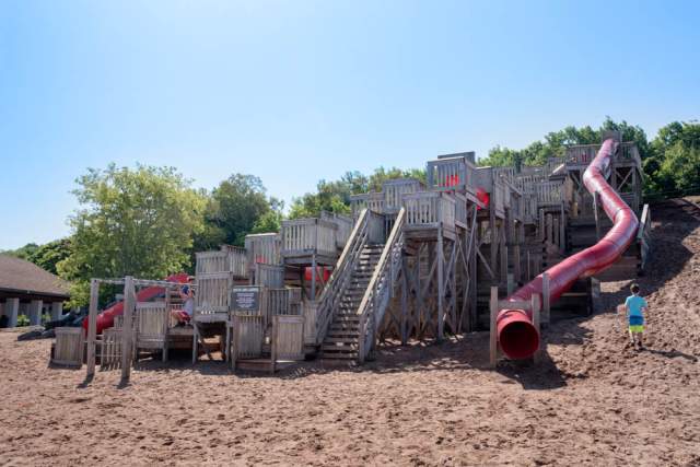 A playground resembling "Chutes and Ladders" board game, with long enclosed slides and many climbable staircases.