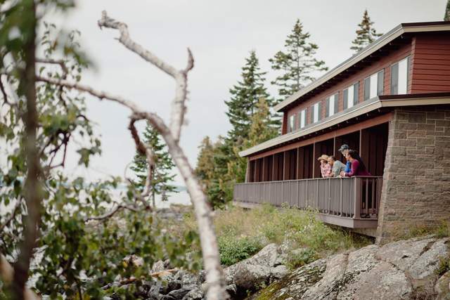 Visitors enjoying the view of Isle Royale National park from a motel room.