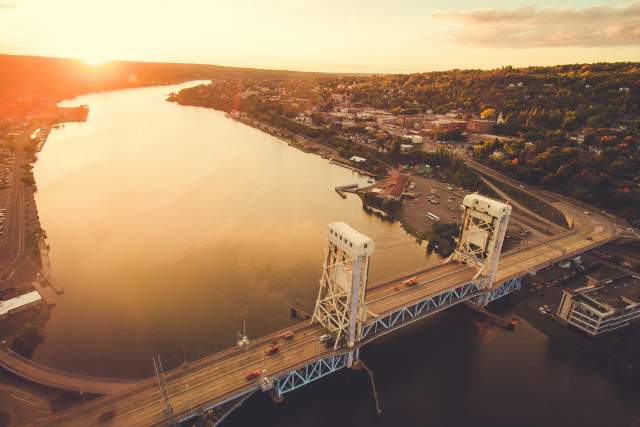 Aerial shot of Portage Lake Lift Bridge at sunset in fall