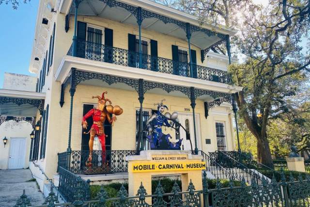 Mardi Gras Museum exterior with two jester statues