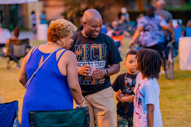 Woman, man and two small children talking