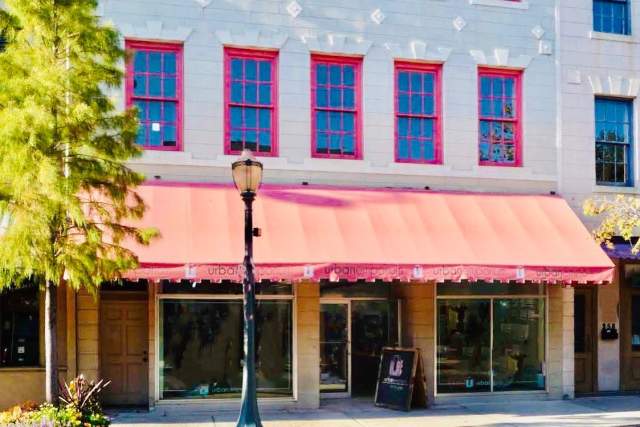Exterior of Urban Emporium: two story building with an awning across the entire first floor