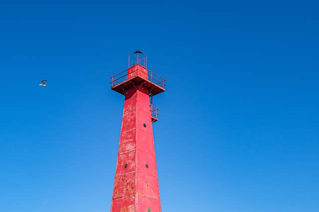 red lighthouse with blue skies