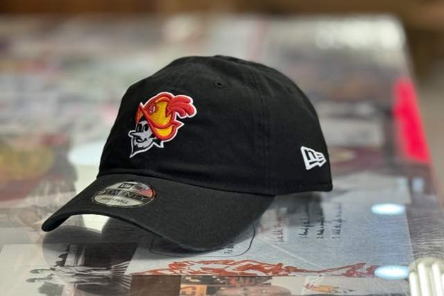Black New Era baseball cap with an Albuquerque Duke logo on a table.