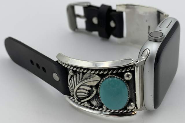 Apple Watch with a decorative silver band featuring a turquoise stone and intricate patterns.