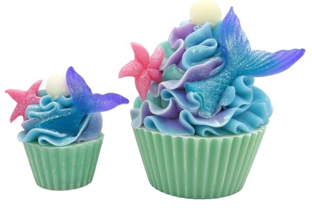 Two cupcake shaped bath treats with ornate, multicolored frosting designed to look like flowers, topped with edible glitter and a small white ball on each.