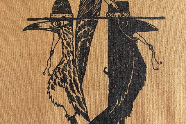 Black print of two birds perched standing back to back, featuring intricate feather details, on a textured golden background. Text reads "New Mexico"