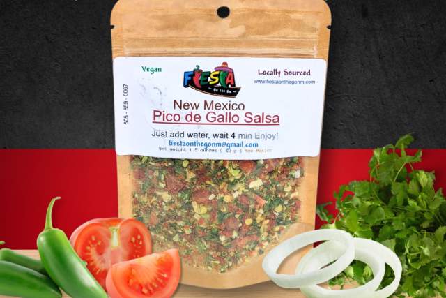 A package of Fiesta on the Go New Mexico Pico de Gallo Salsa on a festive background, surrounded by fresh ingredients including bell peppers, tomatoes, and onions.