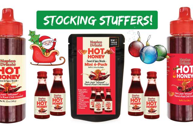 Promotional image for stocking stuffers featuring Naples Drizzle Hot Honey, including three bottles and a variety bag. A festive banner with the text 'Stocking Stuffers!' is displayed above, and holiday decorations including Santa Claus, ornaments, and a stocking are also visible.