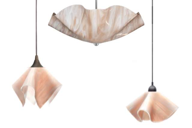 Three hanging lamps with shades that resemble draped fabric in soft peach and champagne tones, each suspended from a simple black cord, displayed against a white background.