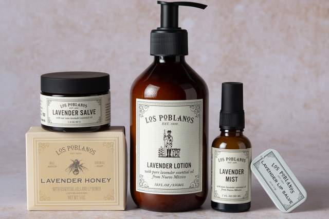 A collection of Los Poblanos branded lavender products, including lavender salve, lavender honey, lavender lotion, and lavender mist, displayed on a neutral background.