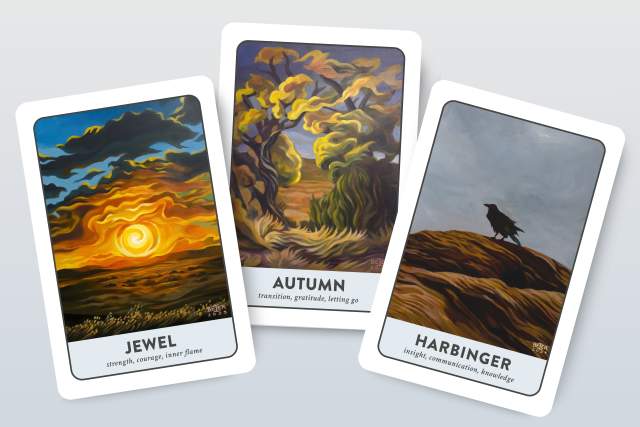Three tarot cards displayed with illustrations depicting a sunset, an autumn landscape and a crow on a cliffside.