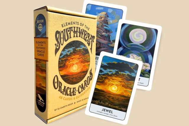 This image shows a boxed set of "Elements of the Southwest Oracle Cards." The front of the box displays a desert landscape with a sun setting behind mountains. Three oracle cards are partially spread out next to the box, featuring colorful abstract designs.