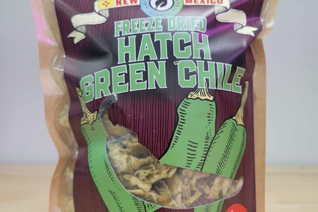 Package of New Mexico freeze-dried Hatch green chile peppers on a countertop.