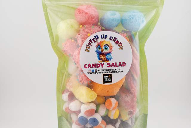 A package of "Puffed Up Candy Candy Salad" from PuffedUpCandy.com. The clear, resealable bag displays a colorful assortment of candy balls in various sizes and colors including pink, blue, yellow, and white.