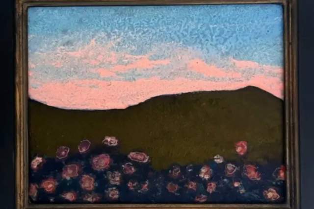 A framed painting depicts a landscape with a colorful sky above a shadowed hill. The foreground shows abstract floral shapes in various shades.