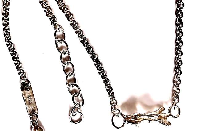 Two metal chains with different link styles and clasps against a white background.