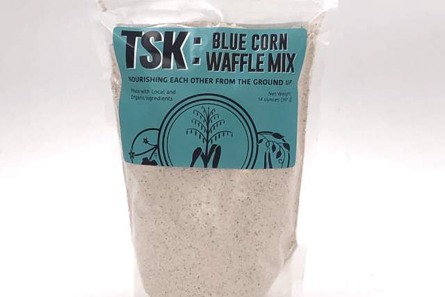 A bag of TSK Blue Corn Waffle Mix on a plain background, highlighting its features and organic ingredients.