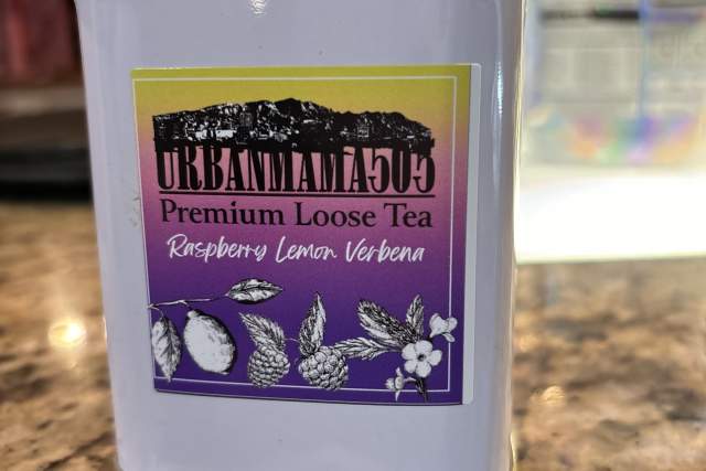 A tin of Urban Momma 505 Premium Loose Tea sits on a granite counter.