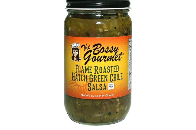 A jar of flame roasted hatch green chile salsa with an orange label sits on a white background. The label reads "The Bossy Gourmet, Flame Roasted Hatch Green Chile Salsa"