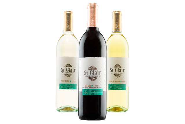 three bottles of wine, one white, one yellow and one red, all with the same white and turquoise label. The label reads St. Clair - New Mexico, Est. 1984. Each wine also has it's name, reading left to right: Pinot Grigio, Cab-Zin, Halvasia Blanca