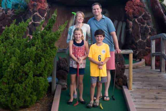 family playing mini golf