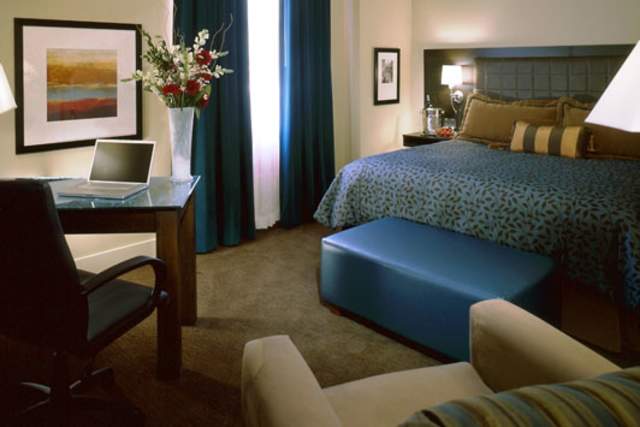 Attractive Hotel Room with Bed, Desk, Chair, and Window