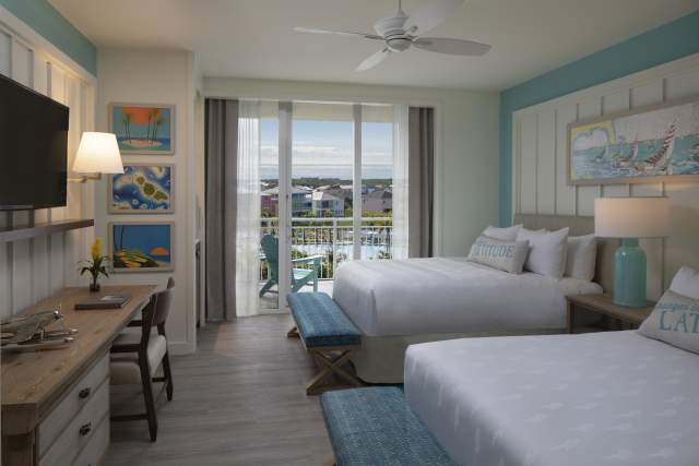 Double guestroom at Margaritaville Resort Orlando with balcony looking out over pool and cottages. Photo by CJ Walker.