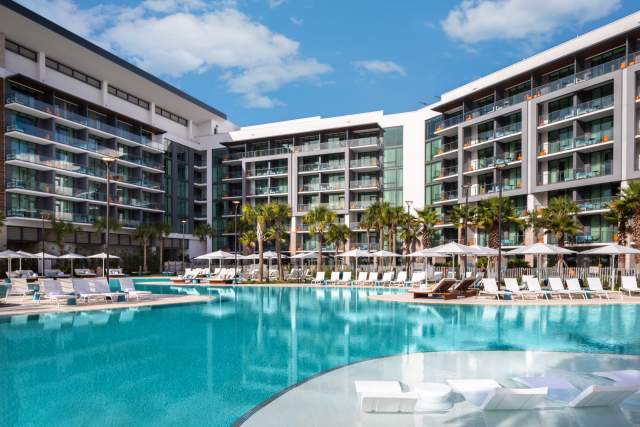 View of pool and hotel exterior at Conrad Orlando