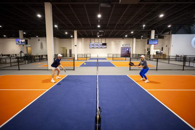 Anna Cooke, director of marketing, faces off against Evan Addington, director of pickleball, at Crush Yard Orlando, a 48,000-square-foot facility that recently opened in Kissimmee on Jan. 14, 2025. (Patrick Connolly/Orlando Sentinel)