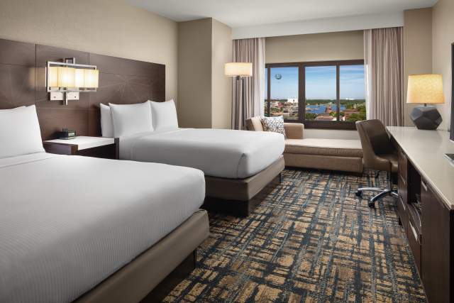 Deluxe room with queen beds and Disney Springs view at Hilton Orlando Lake Buena Vista