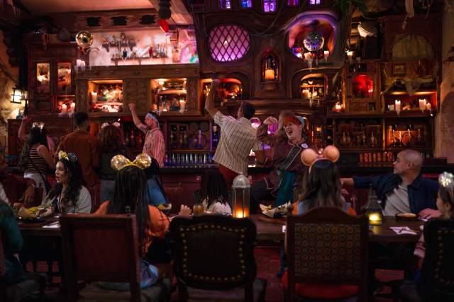 Cast Members and guests celebrate at The Beak & Barrel, a pirate-themed tavern at Magic Kingdom Park, part of Walt Disney World Resort in Orlando.