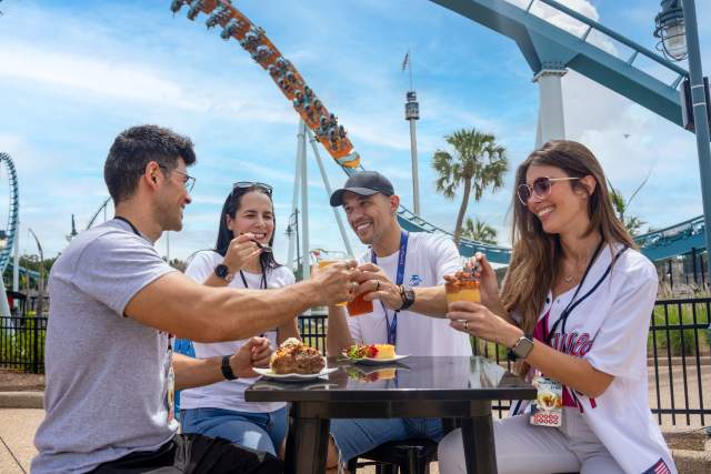 Two couples enjoy food and beverages at SeaWorld Orlando's Red, White & BBQ event.