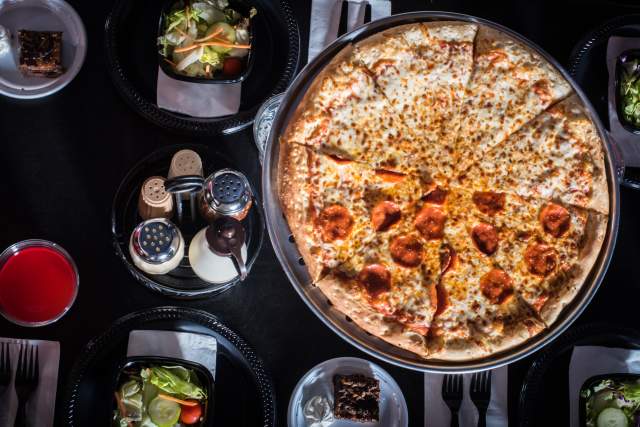 The Outta Control Magic Comedy Dinner Show pizza and salad